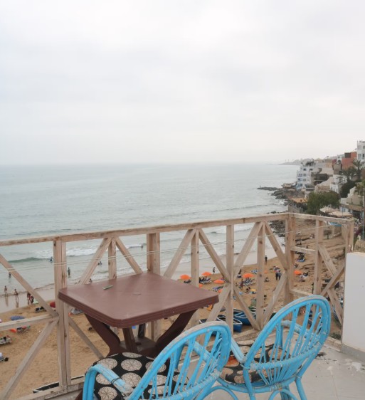 Balcony with blue chairs overlooking Taghazout beach